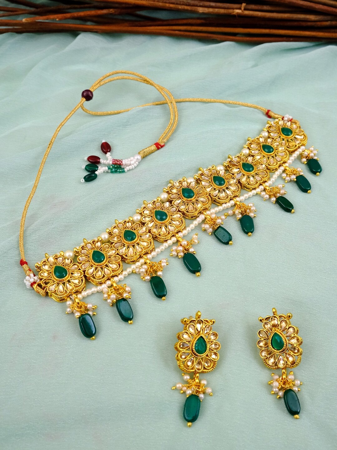

Crunchy Fashion Gold-Plated Green Stone-Studded & Beaded Antique Jewellery Set