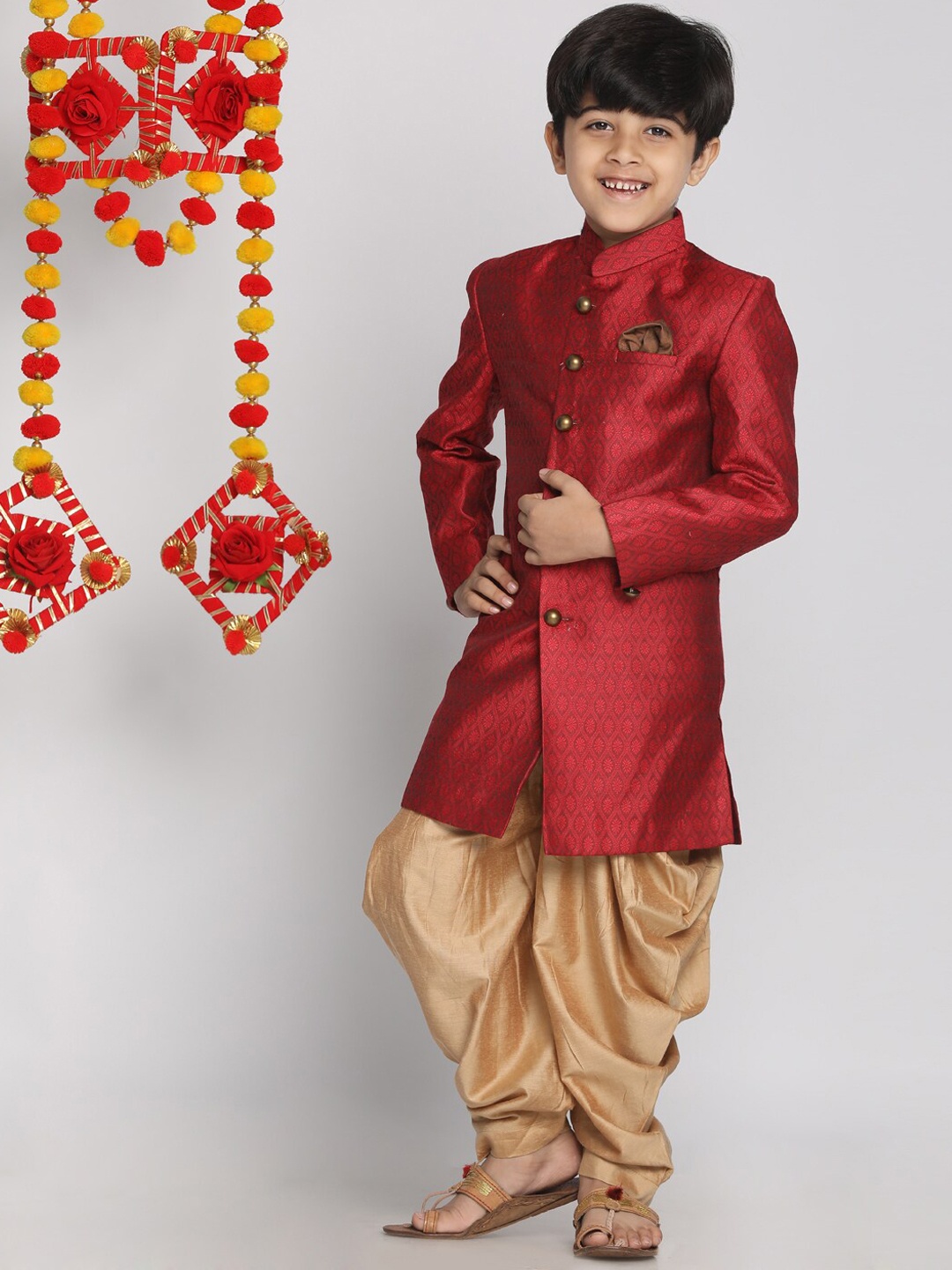 

Vastramay Boys' Maroon And Rose Gold Indowestern Sherwani and Cowl Dhoti Pant Set