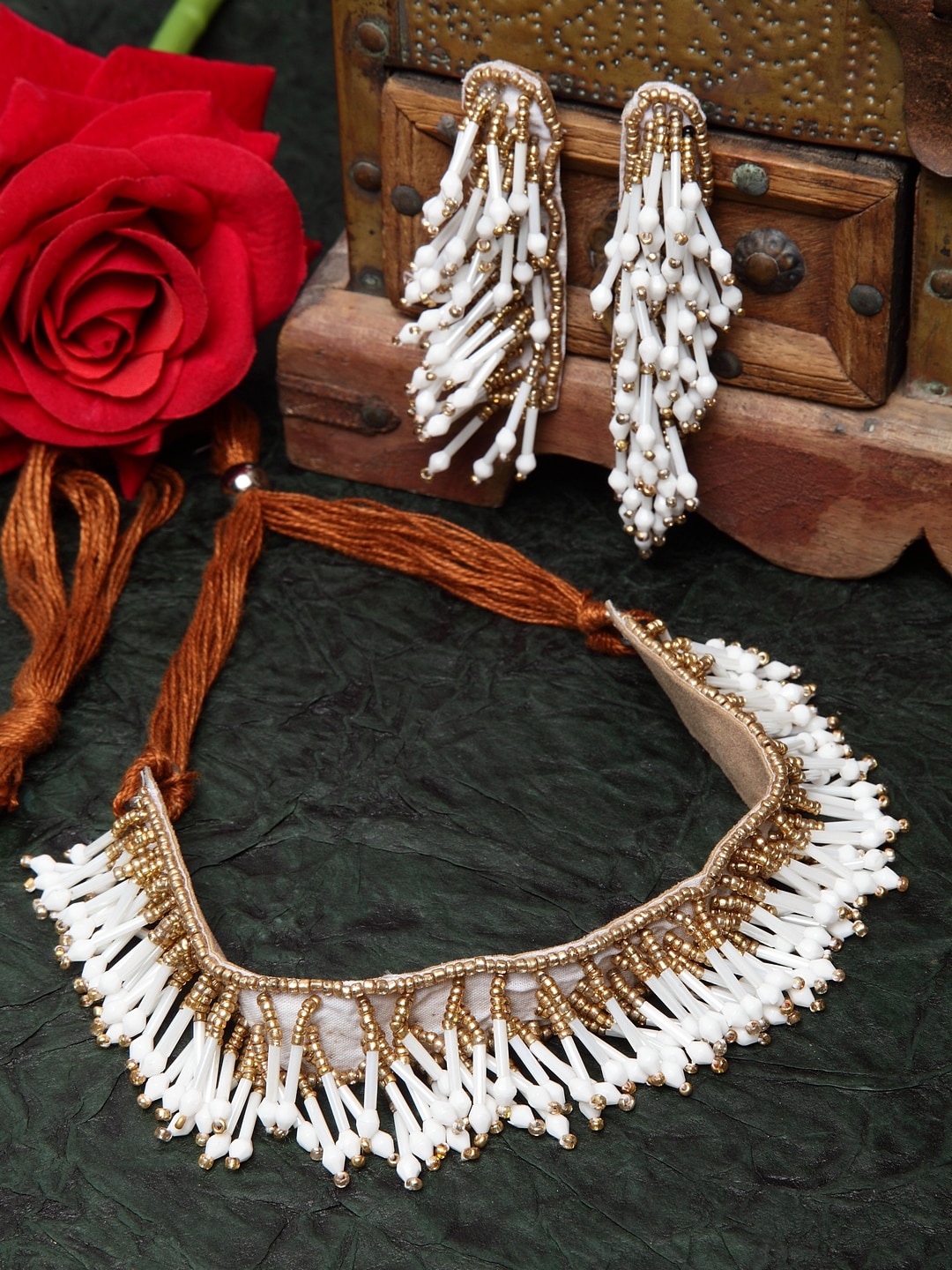 

Moedbuille Off White Beads and Stones Studded Tasselled Afghan Design Jewellery Set