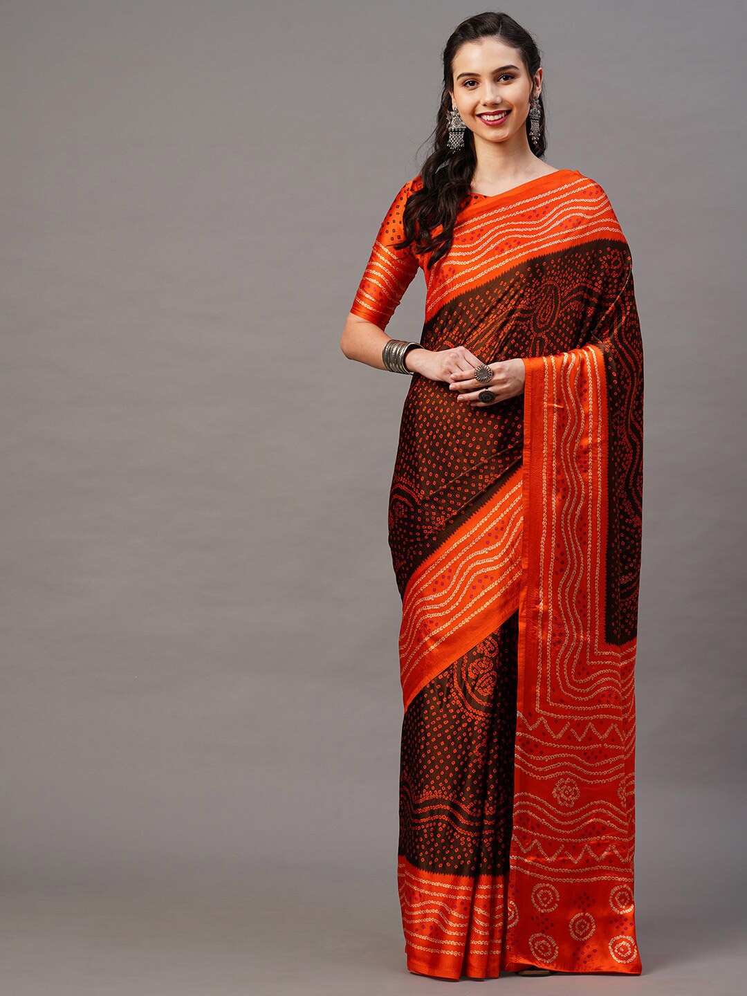 

Mitera Brown & Orange Bandhani Saree