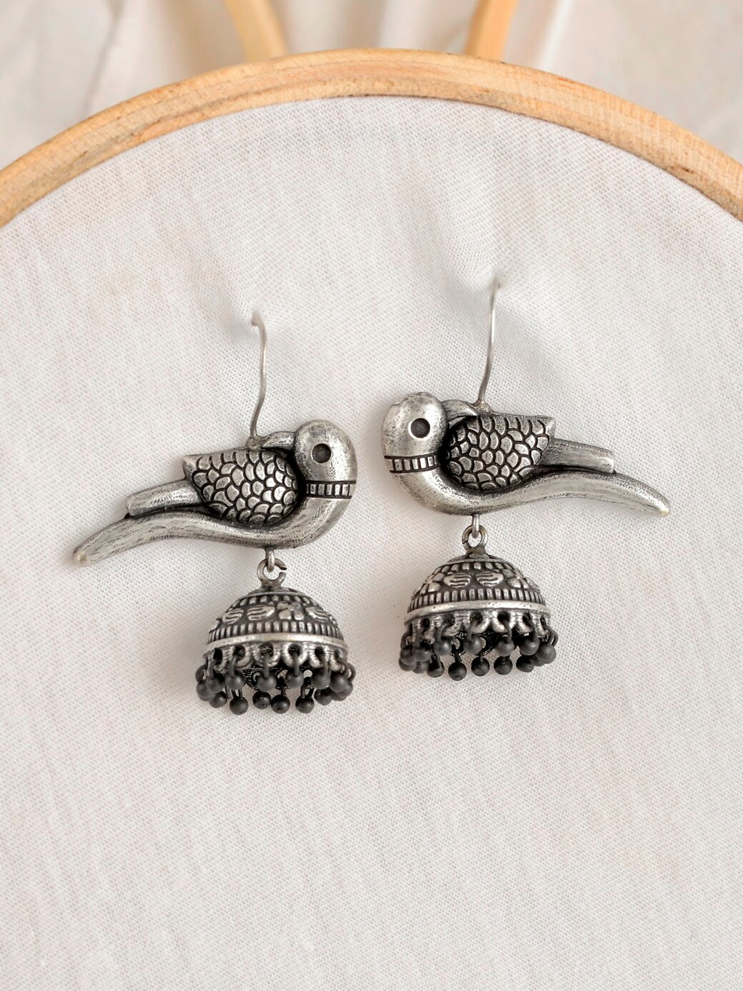

Infuzze Silver-Toned & Plated Dome Shaped Oxidised Jhumkas Earrings