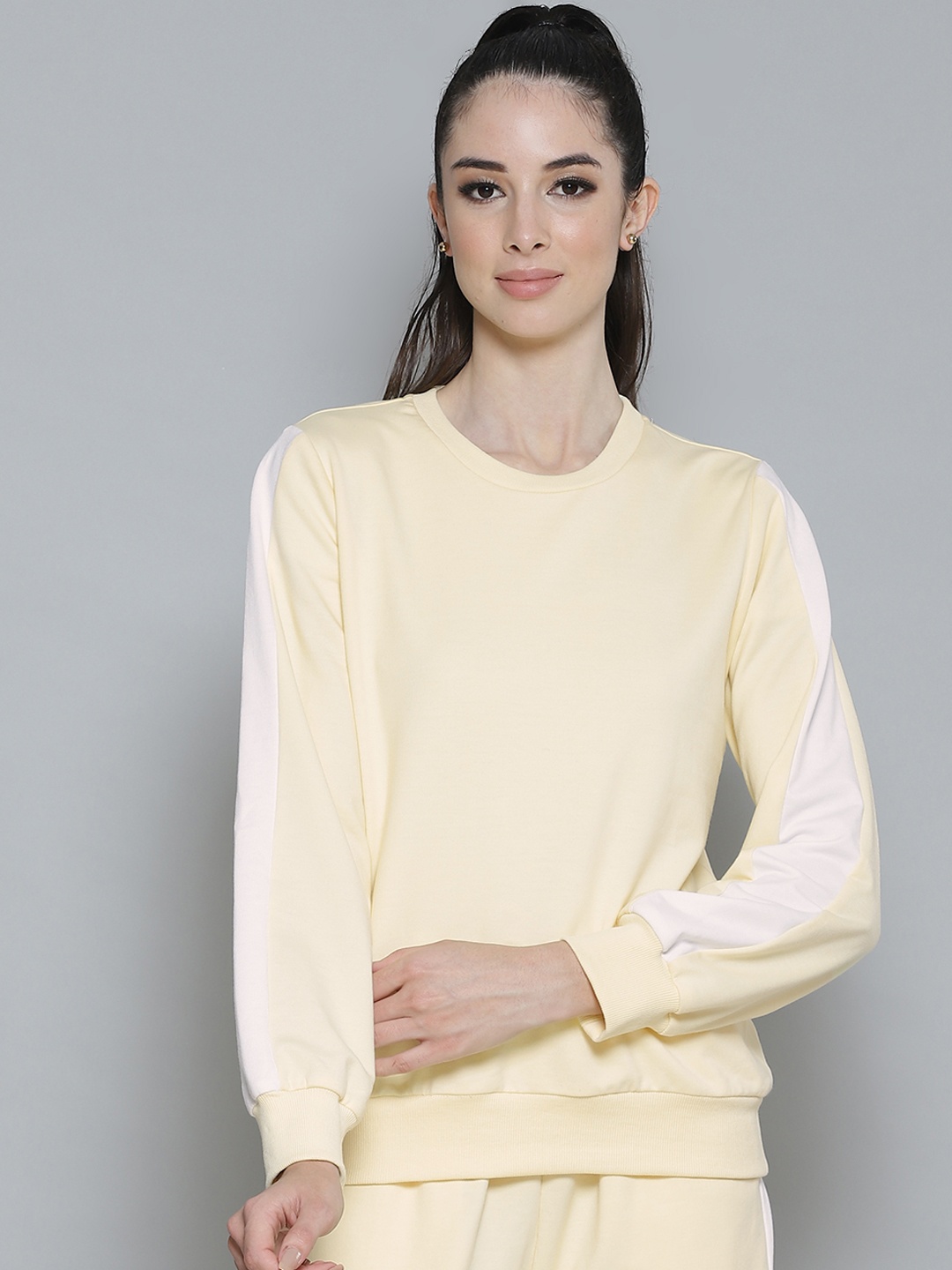 

Femella Women Yellow Solid Sweatshirt