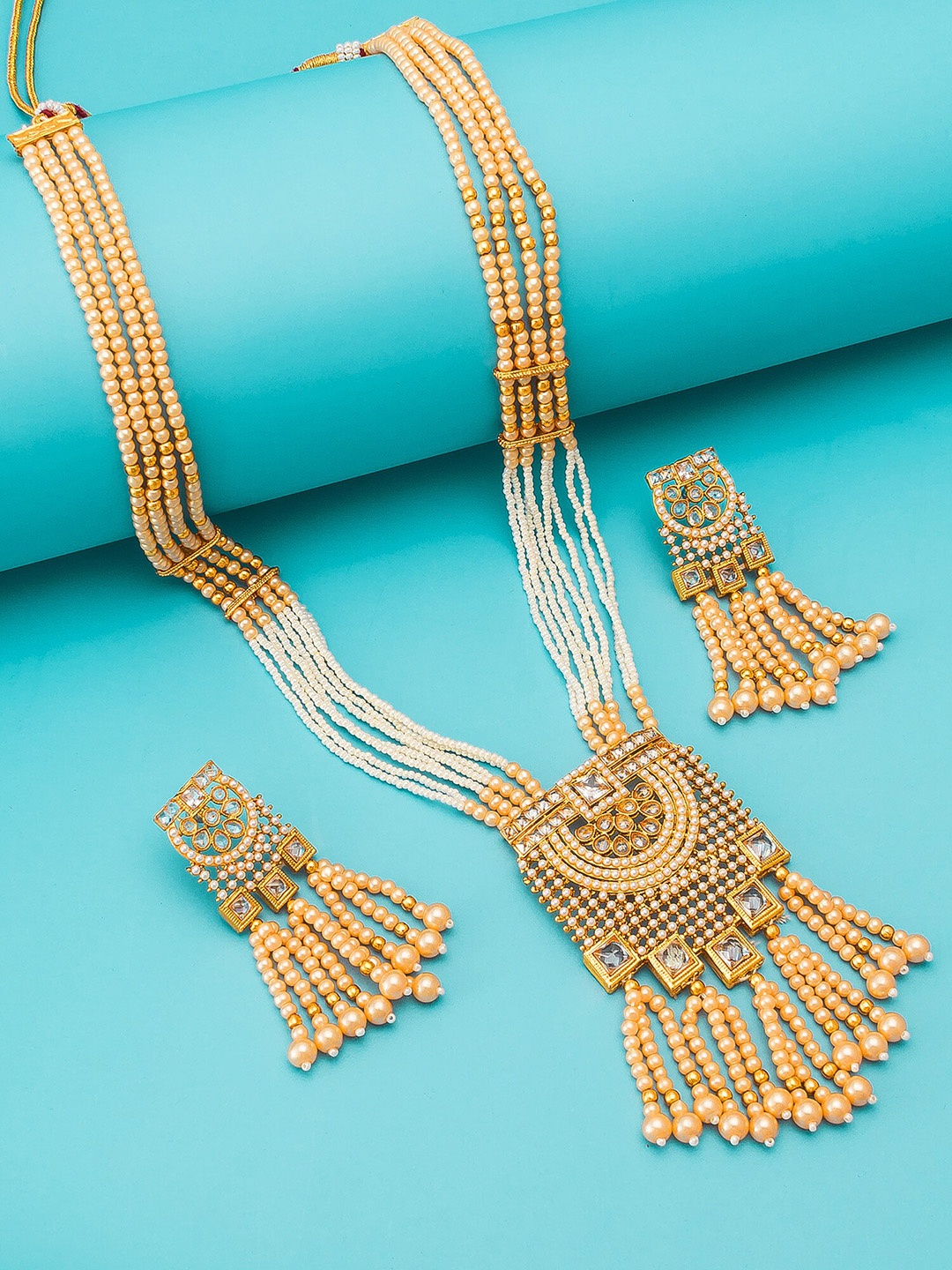 

aadita Gold-Toned & Beige Gold-Plated Stone-Studded Tasselled Jewellery Set