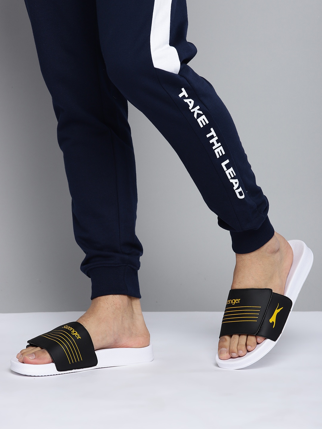 

Slazenger Men Black & Mustard Yellow Striped & Brand Logo Print Sliders