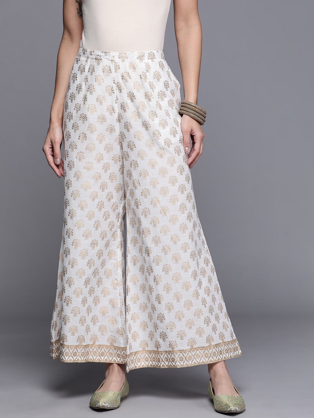 

Libas Women White & Golden Ethnic Motifs Print Cotton Flared Cropped Palazzos