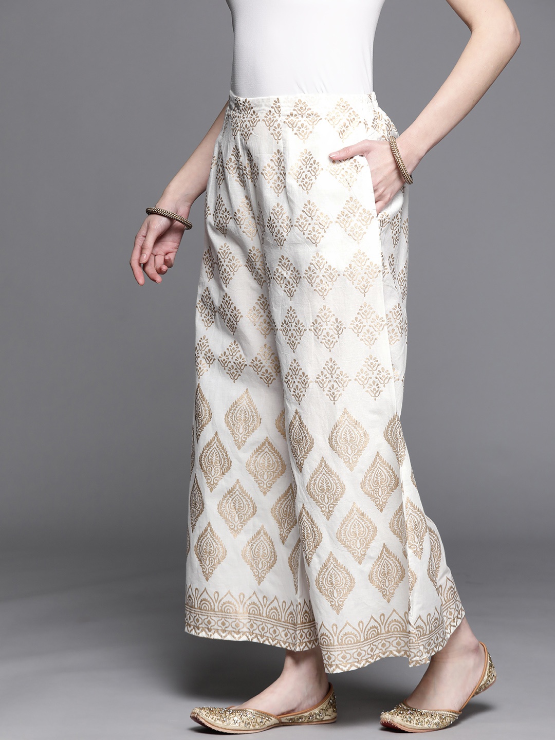 

Libas Women White & Golden Ethnic Motifs Printed Flared Palazzos
