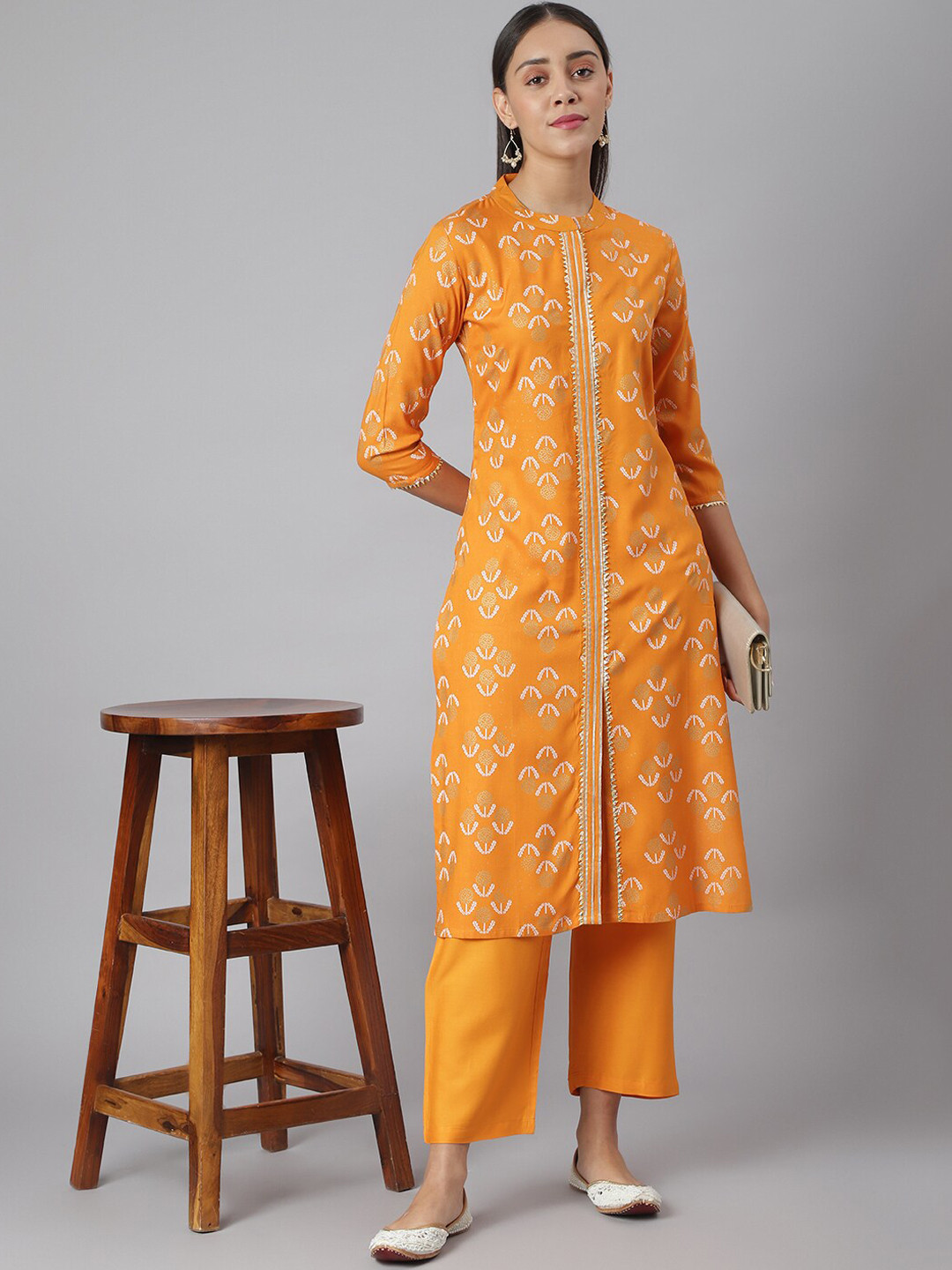 

Khushal K Women Mustard Yellow Floral Printed Regular Kurta with Palazzos