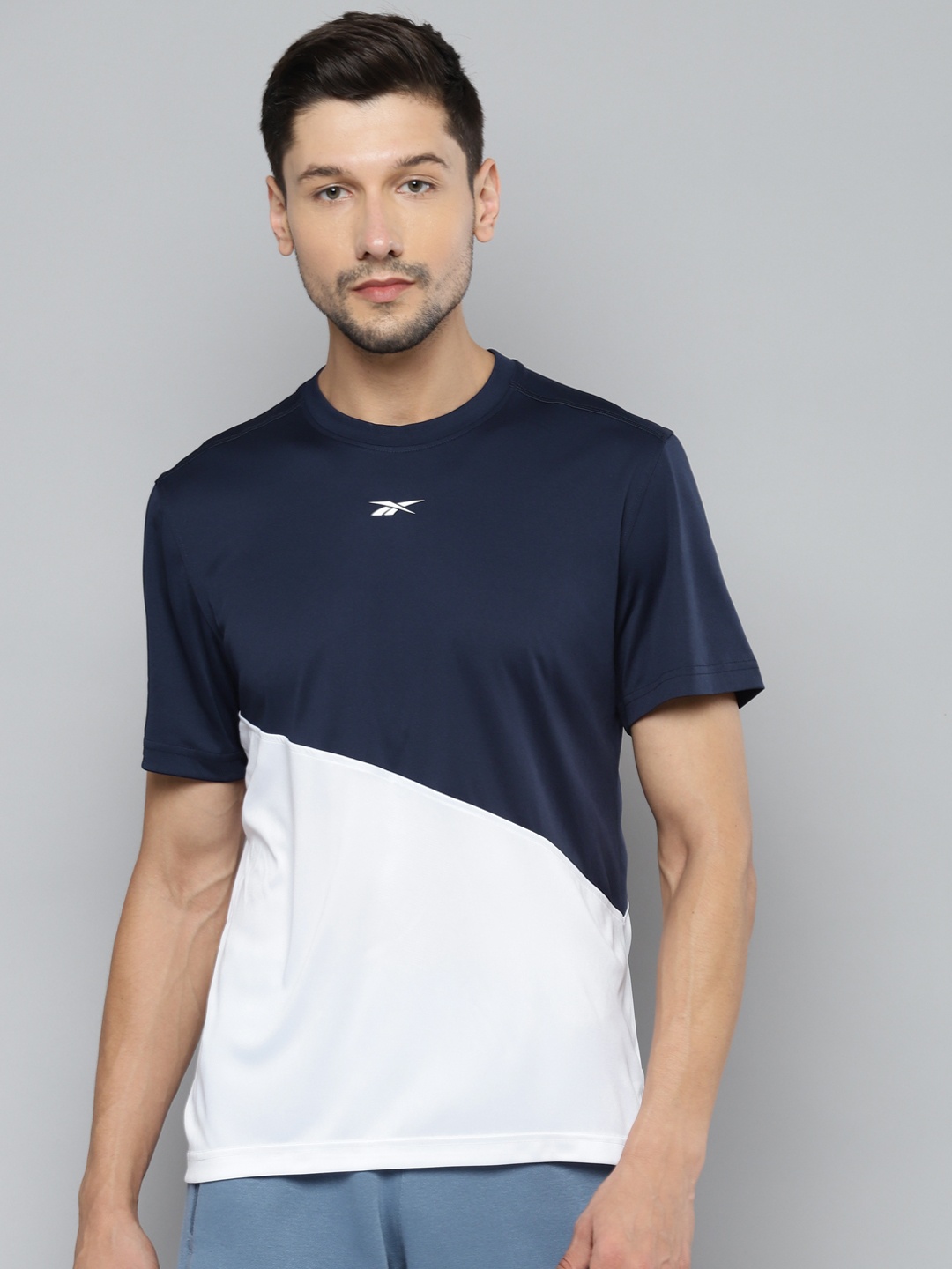 

Reebok Men Navy Blue & White Colourblocked T-shirt