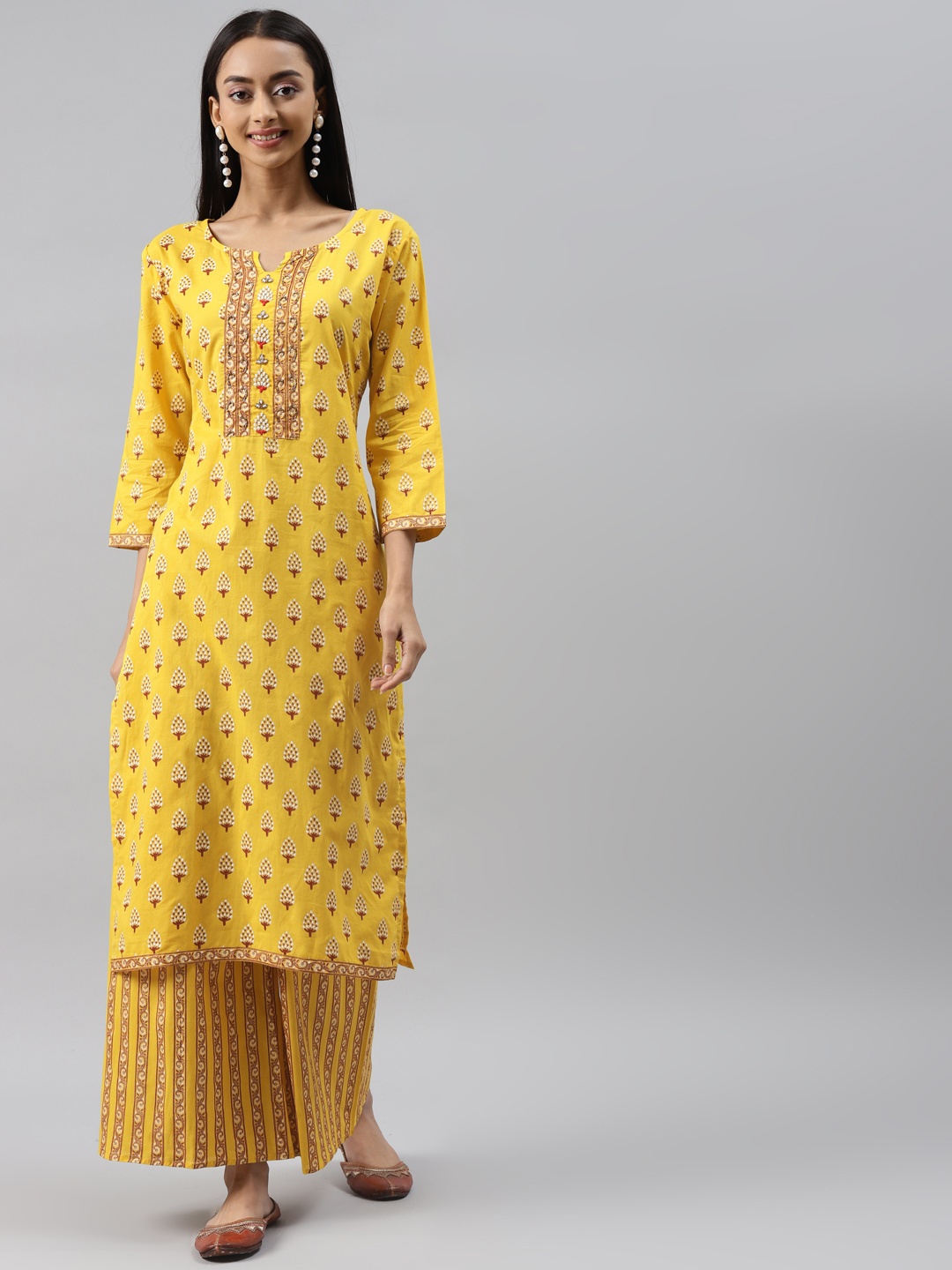 

Meeranshi Yellow Ethnic Motifs Printed Sequinned Pure Cotton Kurta with Trousers