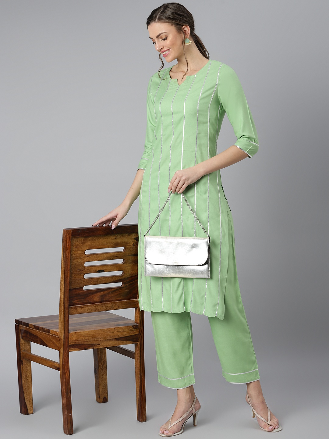 

Khushal K Women Green Striped Regular Kurta with Trousers