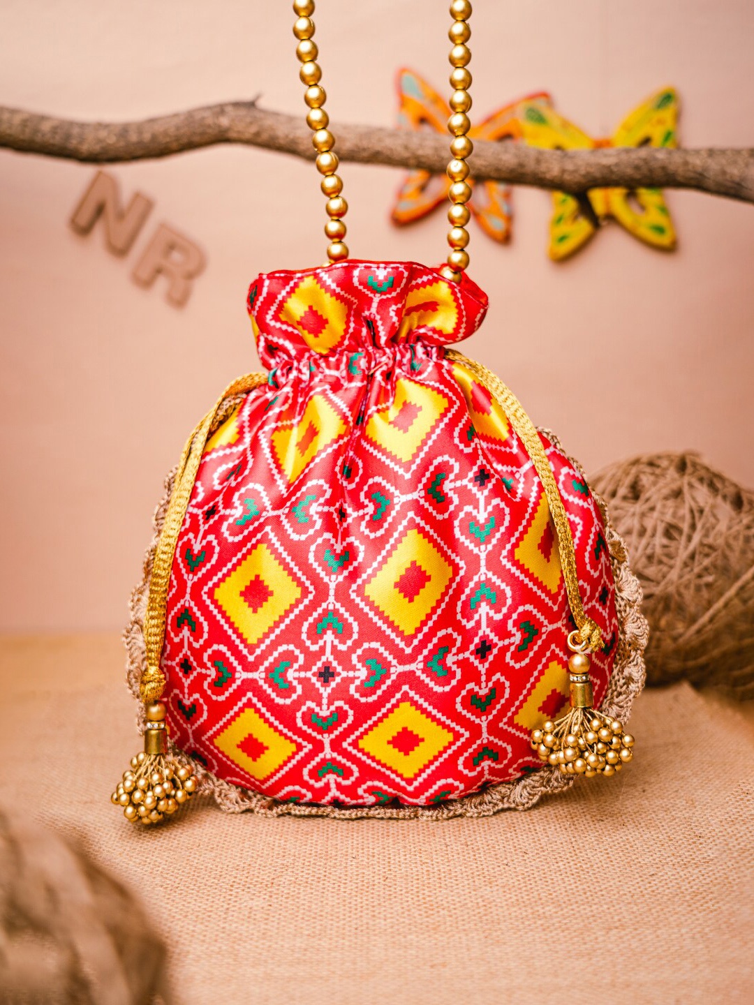 

NR By Nidhi Rathi Pink & Yellow Patola Printed Potli Clutch