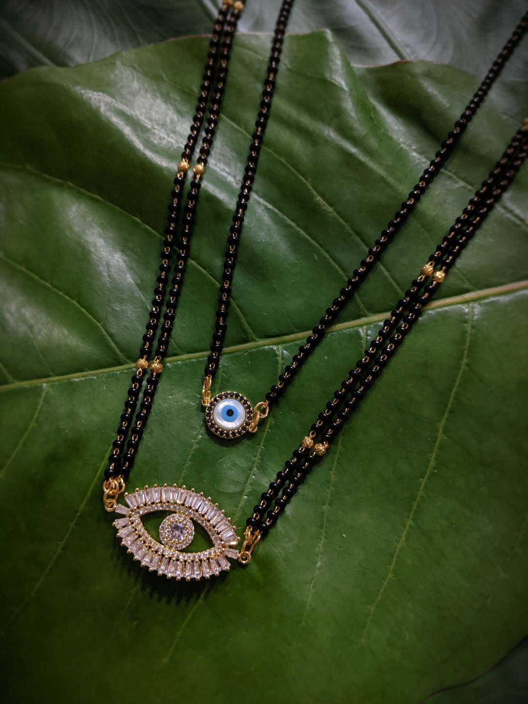 

Digital Dress Room Set Of 2 Gold-Plated White Stone-Studded & Black Beaded Mangalsutra