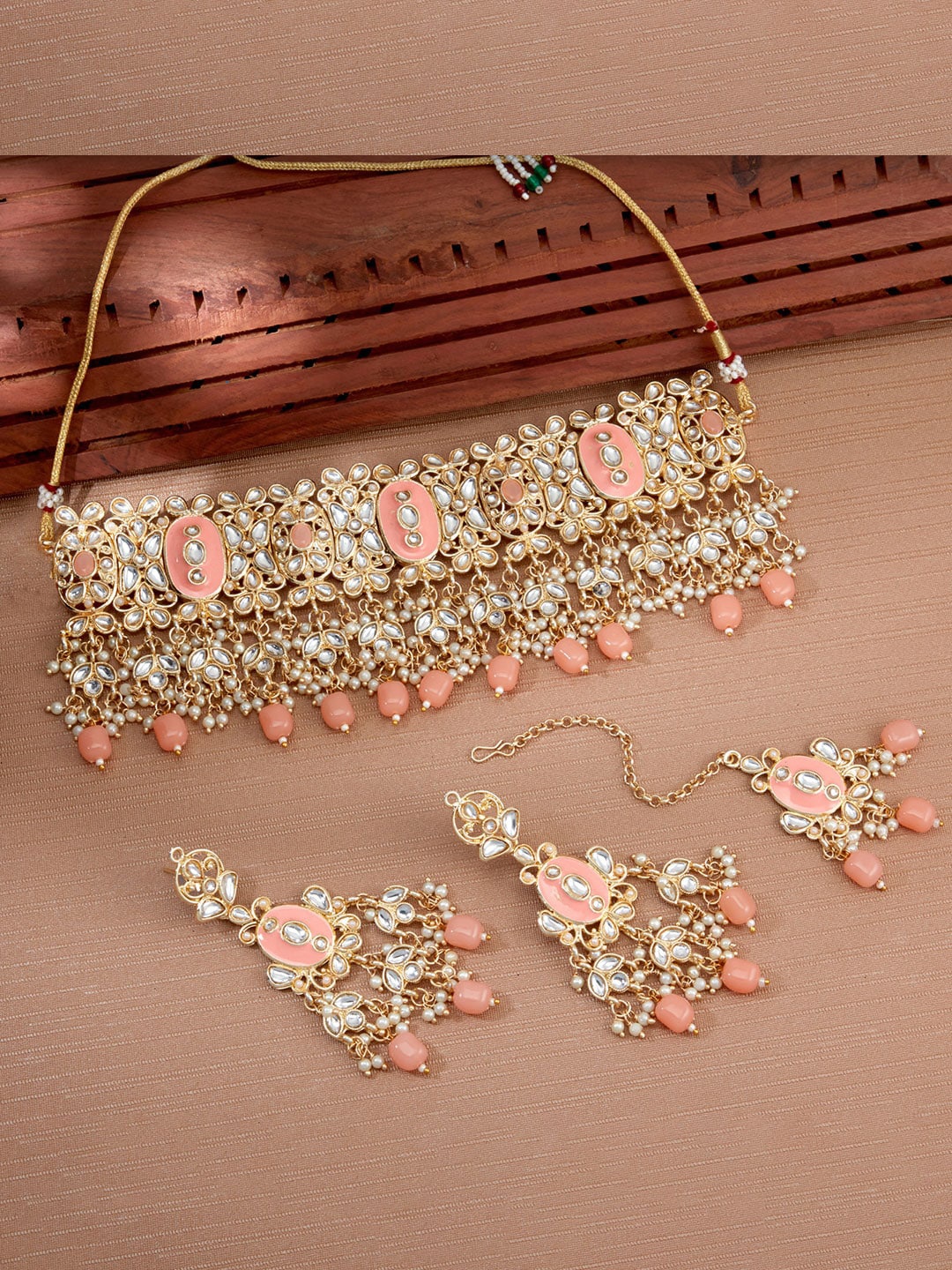 

Sukkhi Gold-Plated Pink Kundan & White Beaded Studded Meenakari Jewellery Set