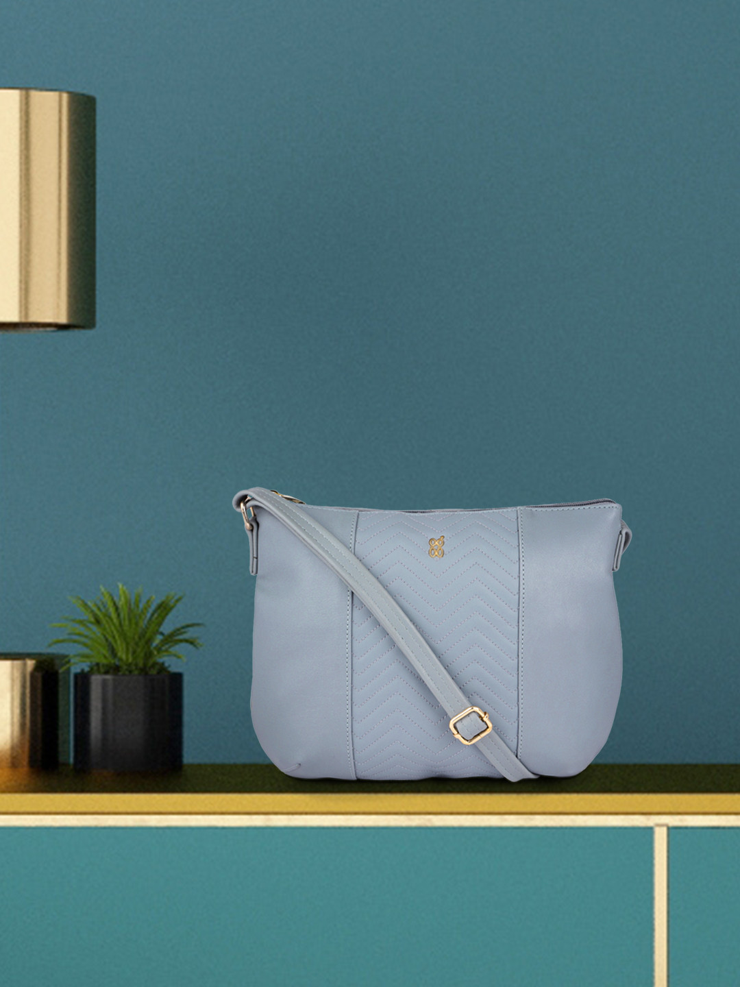 

Baggit Blue Solid Synthetic Leather Regular Structured Sling Bag with Quilted Detail