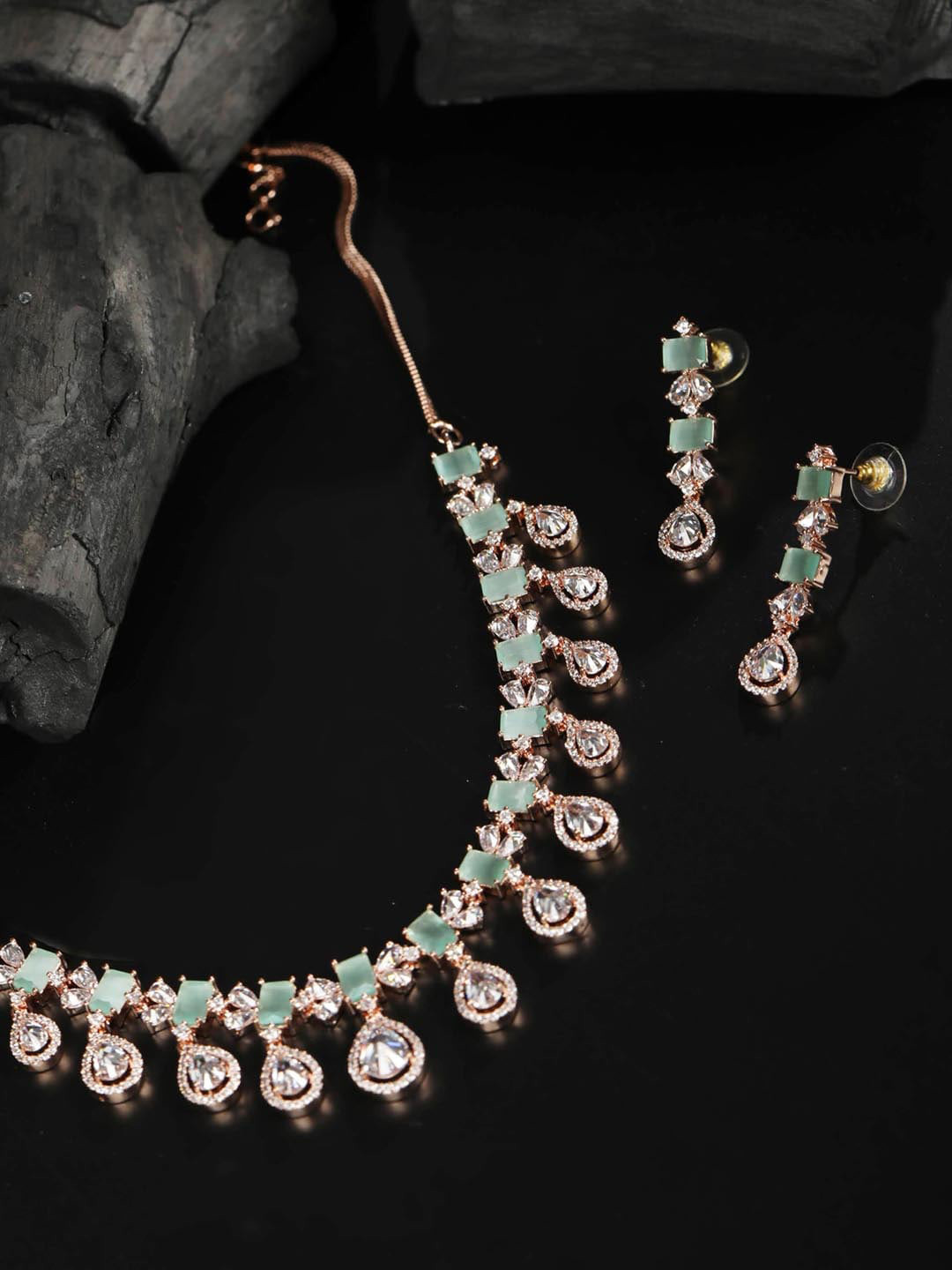 

Priyaasi Woman Rose Gold Plated White & Green American Diamond Studded Jewellery Set