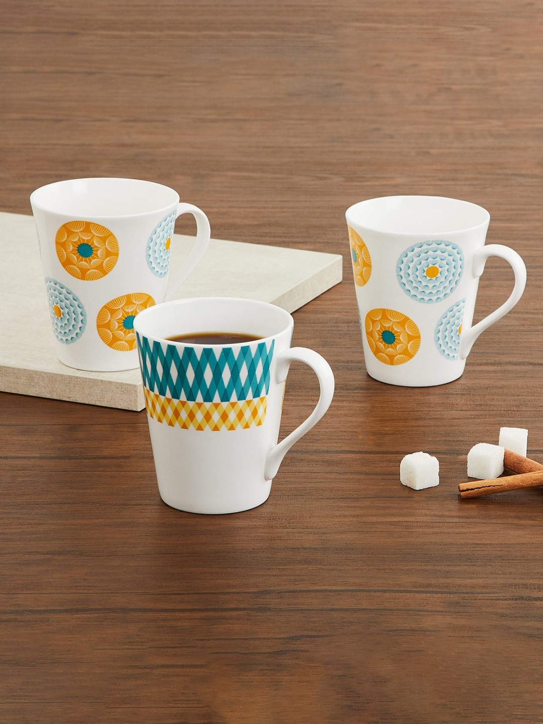 

Home Centre Blue & Yellow Printed Bone China Glossy Mugs Set of Cups and Mugs