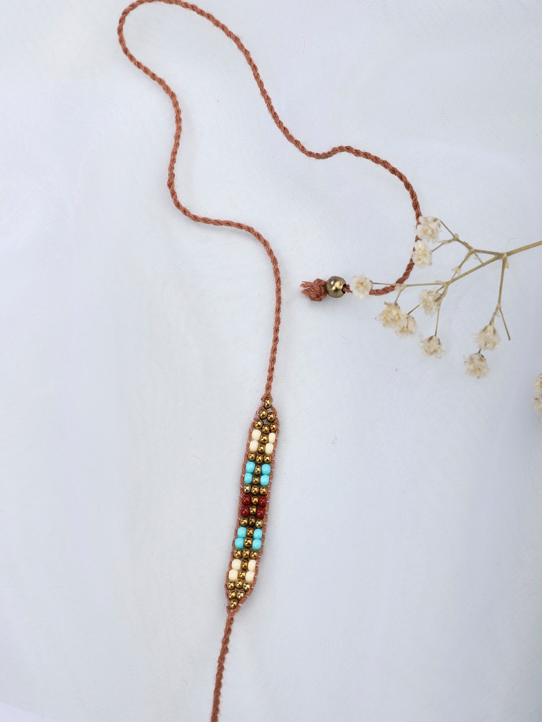 

Fabindia Beige Beads Rakhi