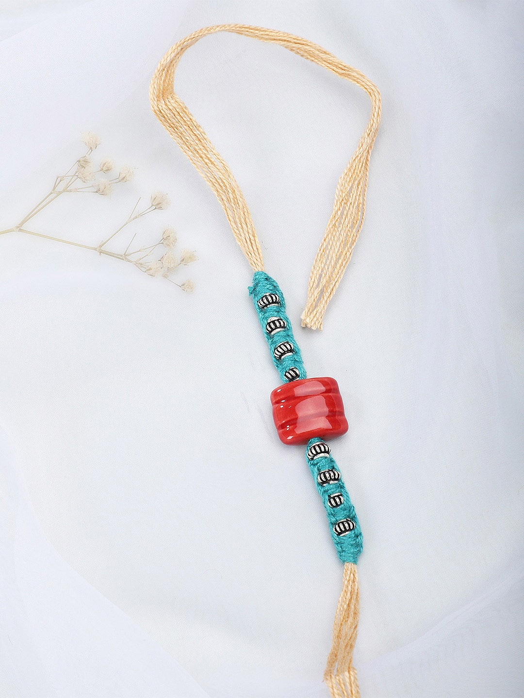 

Fabindia Beige & Blue Thread Rakhi