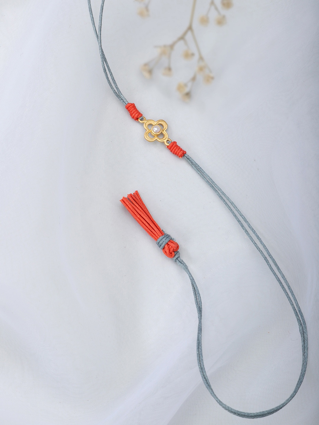 

Fabindia Grey & Orange Thread Rakhi