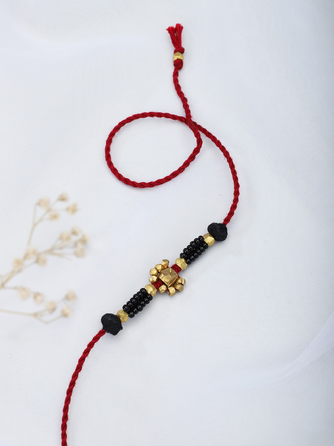 

Fabindia Maroon & Gold-Toned Thread Rakhi