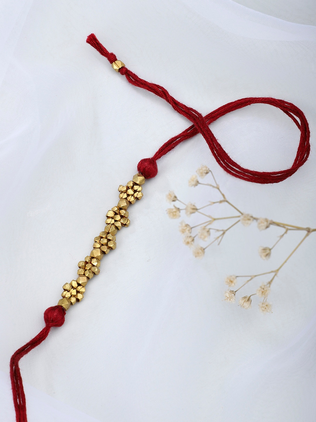 

Fabindia Gold-Toned & Maroon Thread Rakhi