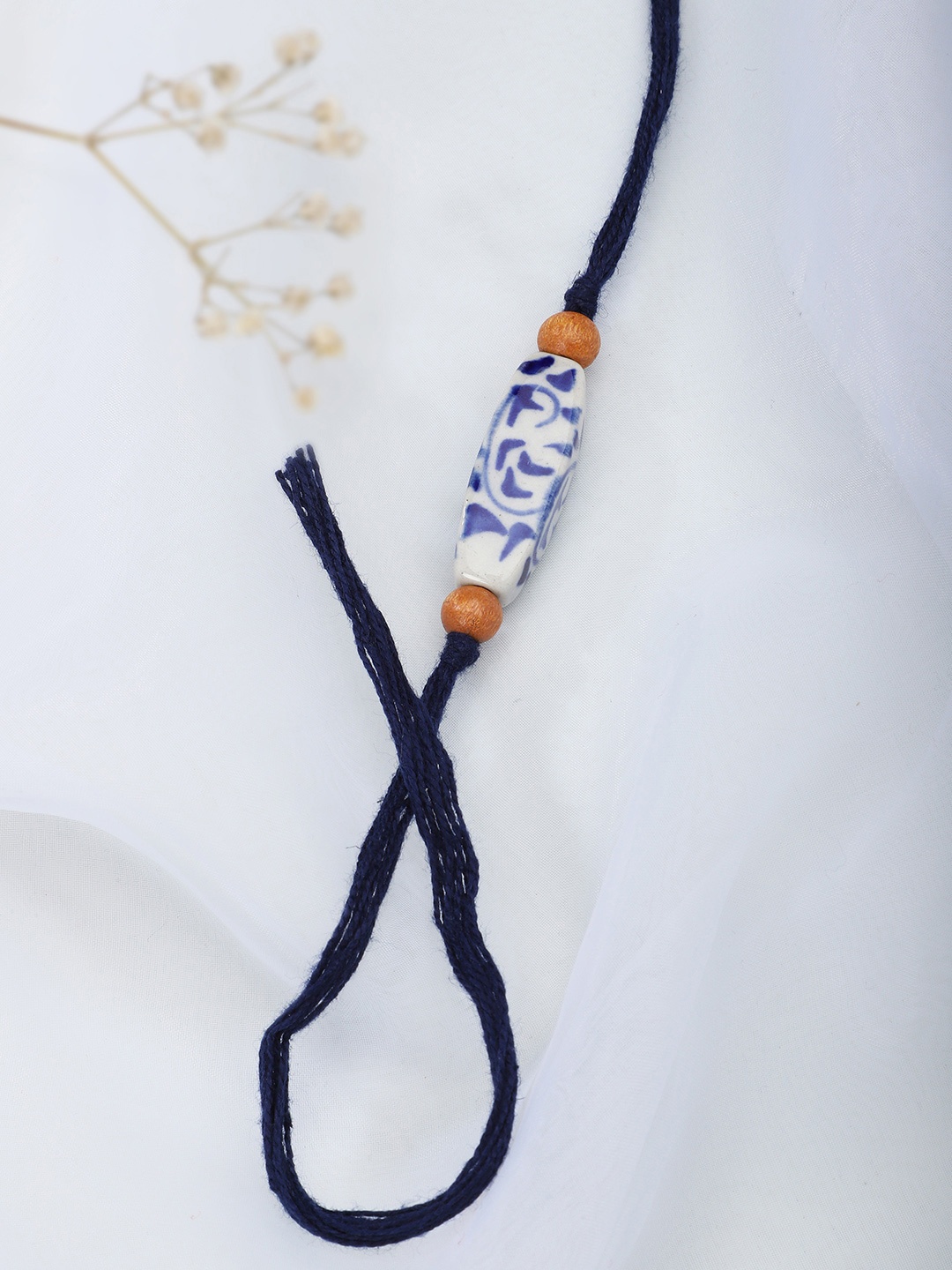 

Fabindia Women Blue & White Thread Rakhi