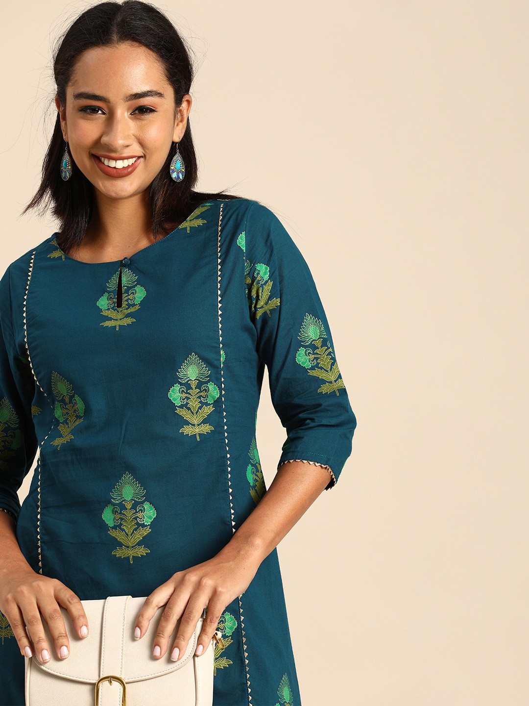 

Janasya Women Teal Green Floral Printed Keyhole Neck Gotta Patti Asymmetric Kurta