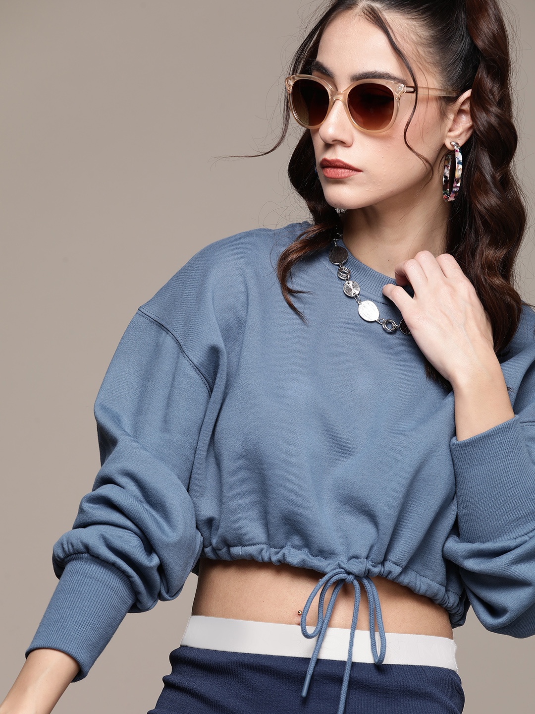 

URBANIC Women Blue Solid Sweatshirt with Waist Tie-Ups