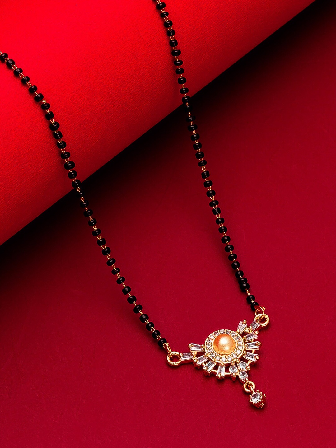 

aadita Woman Gold-Plated White Stone & Black Beaded Mangalsutra