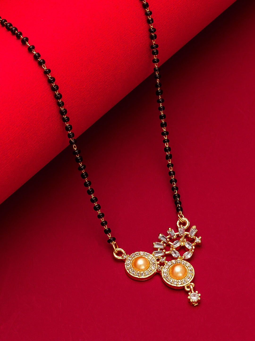 

aadita Gold-Plated White Stone-Studded & Black Beaded Mangalsutra