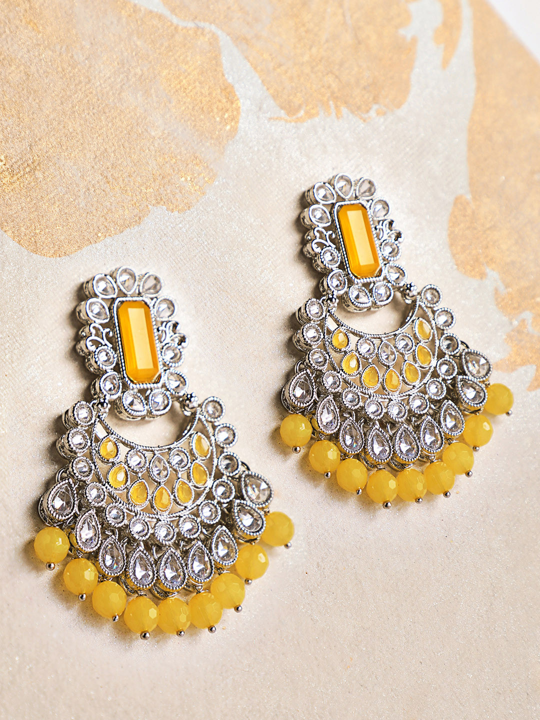 

Rubans Silver-Toned & Yellow AD Studded Crescent Shaped Chandbalis Earrings