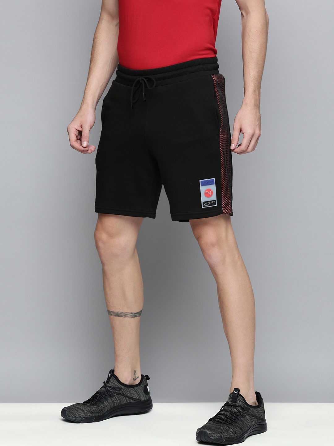 

Puma Men Black Striped Printed Sports Shorts