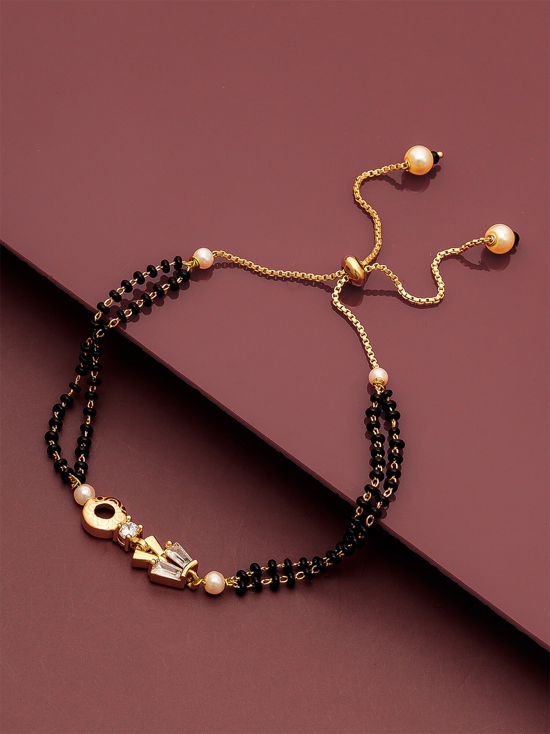 

aadita Gold-Toned & Black Brass AD-Studded Gold-Plated Mangalsutra Link Bracelet