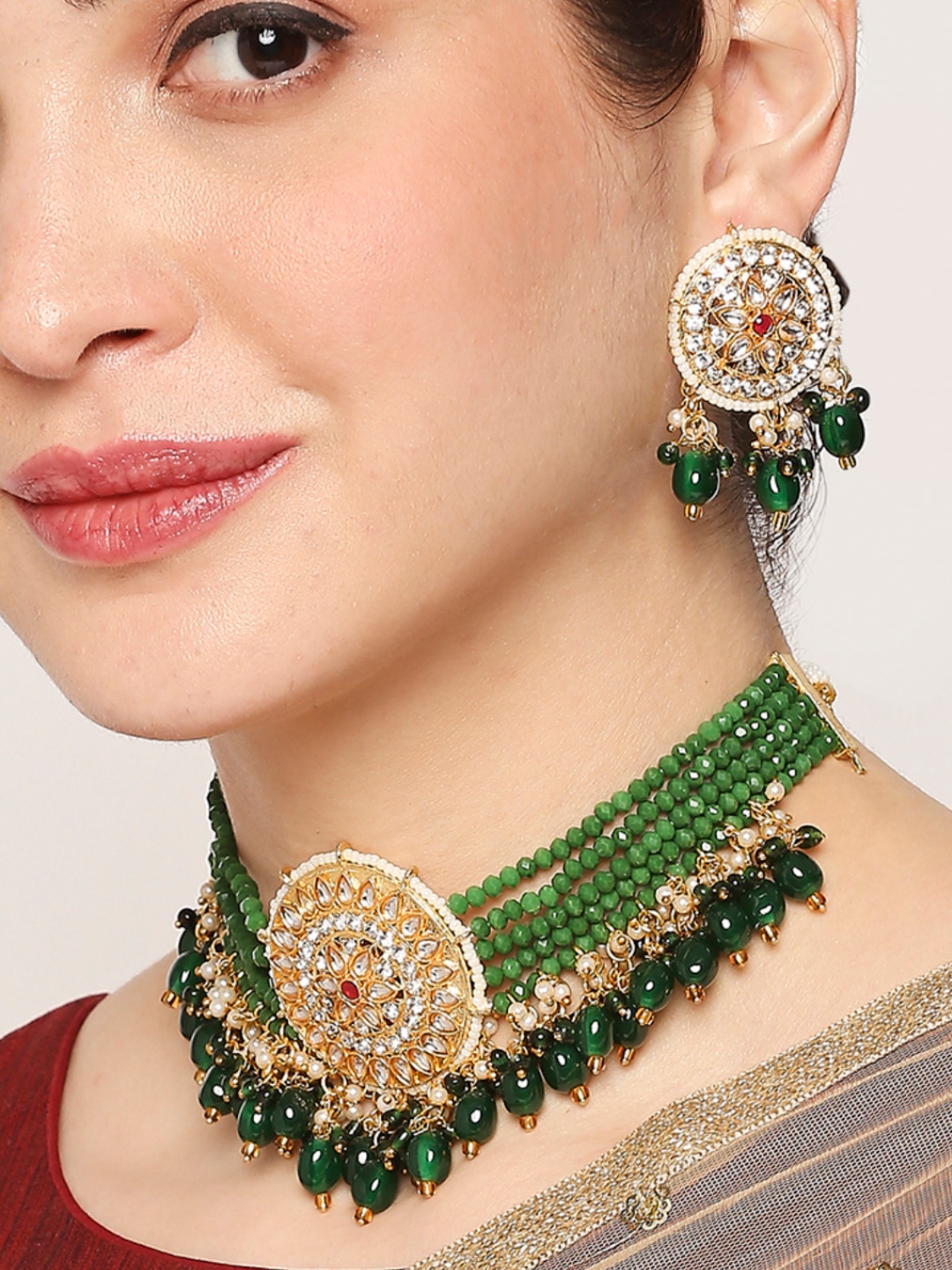 

OOMPH Gold-Toned & White Kundan Studded & Green Beaded Jadau Jewellery Set