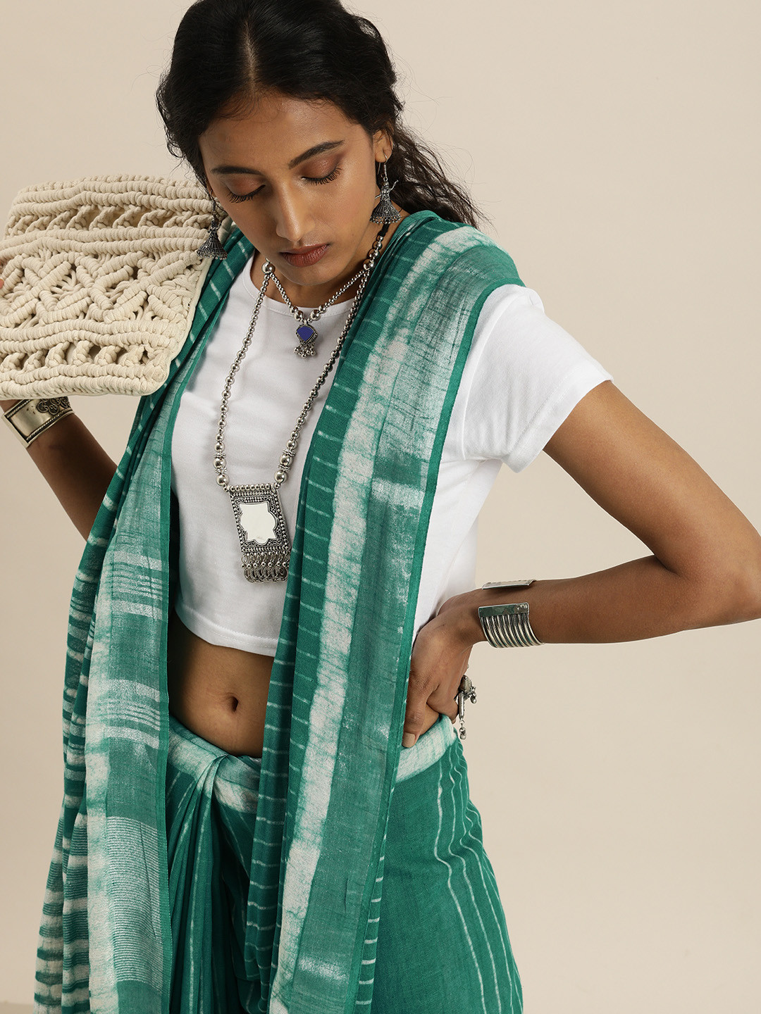 

Taavi Teal Green & White Dabu Striped Saree