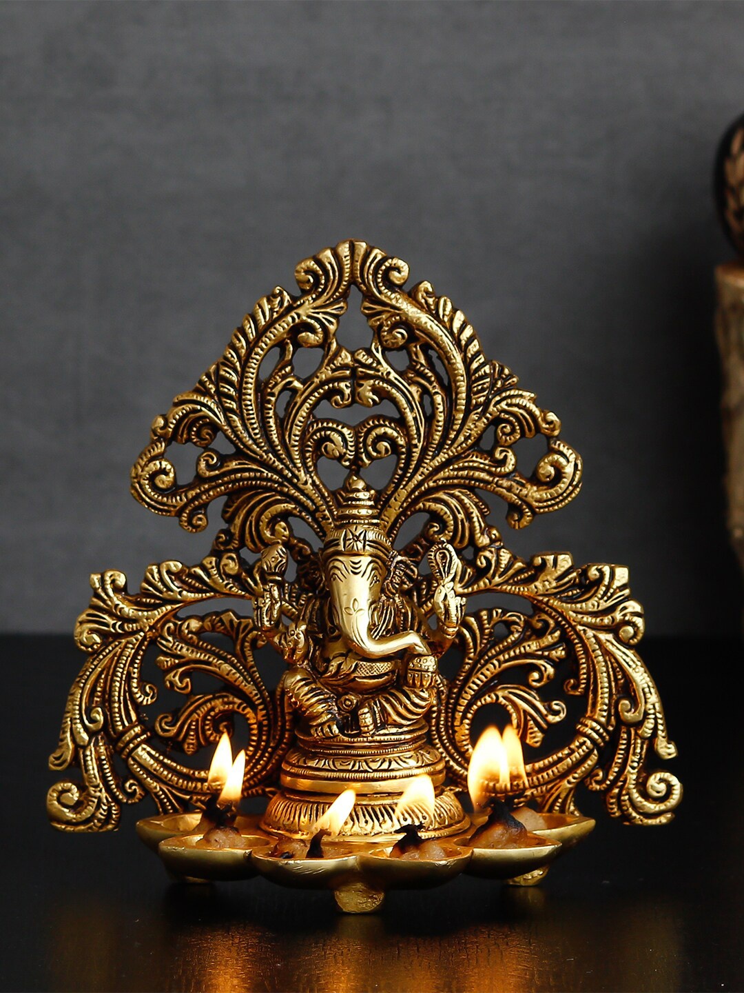 

eCraftIndia Gold-Toned Handcrafted Lord Ganesha Brass Idol With 6 Diya Wicks