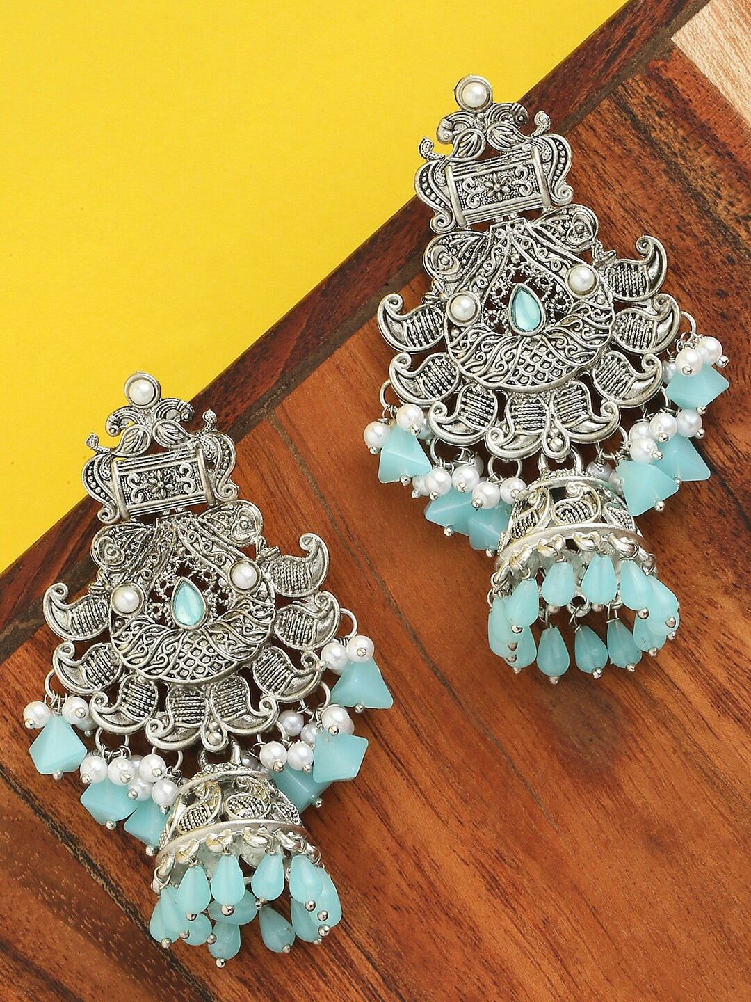 

OOMPH Silver-Toned & Turquoise Blue Dome Shaped Jhumkas Earrings