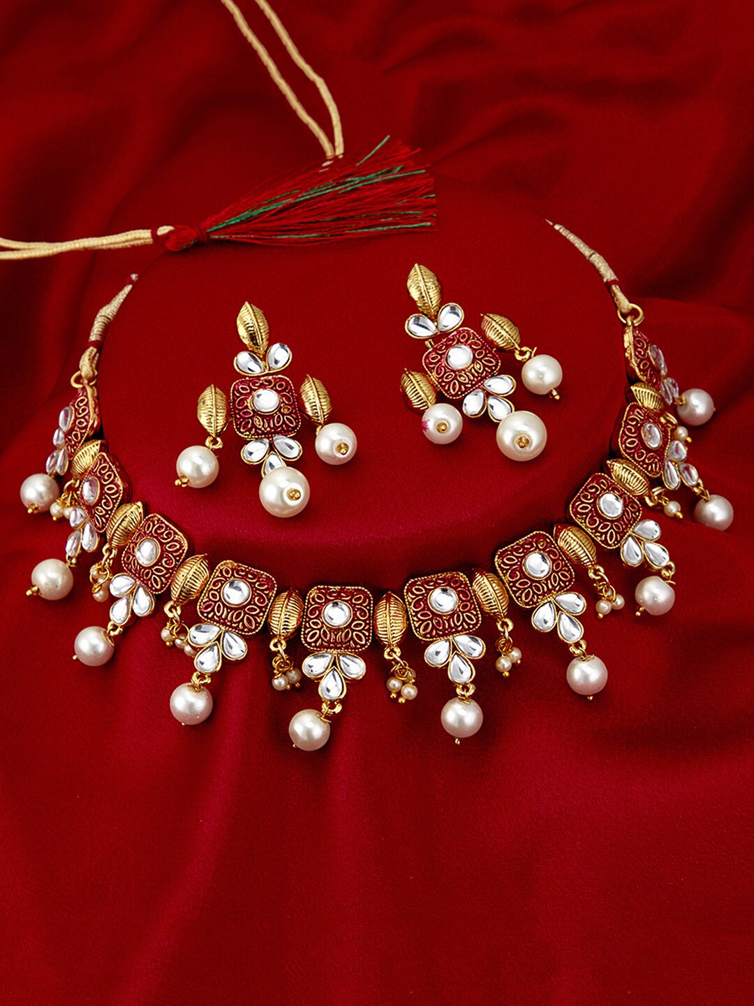 

Sukkhi Gold-Plated White Kundan-Studded & Pearl Beaded Enamelled Jewellery Set