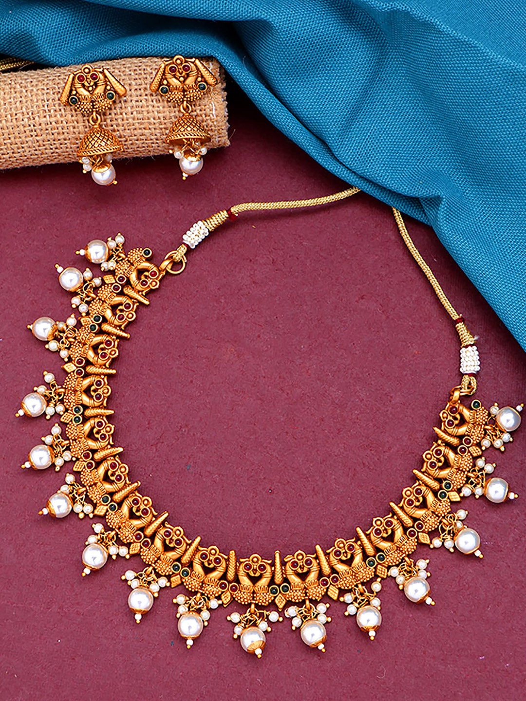 

aadita Gold-Plated White & Red Stone-Studded & Pearl Beaded Handcrafted Jewellery Set