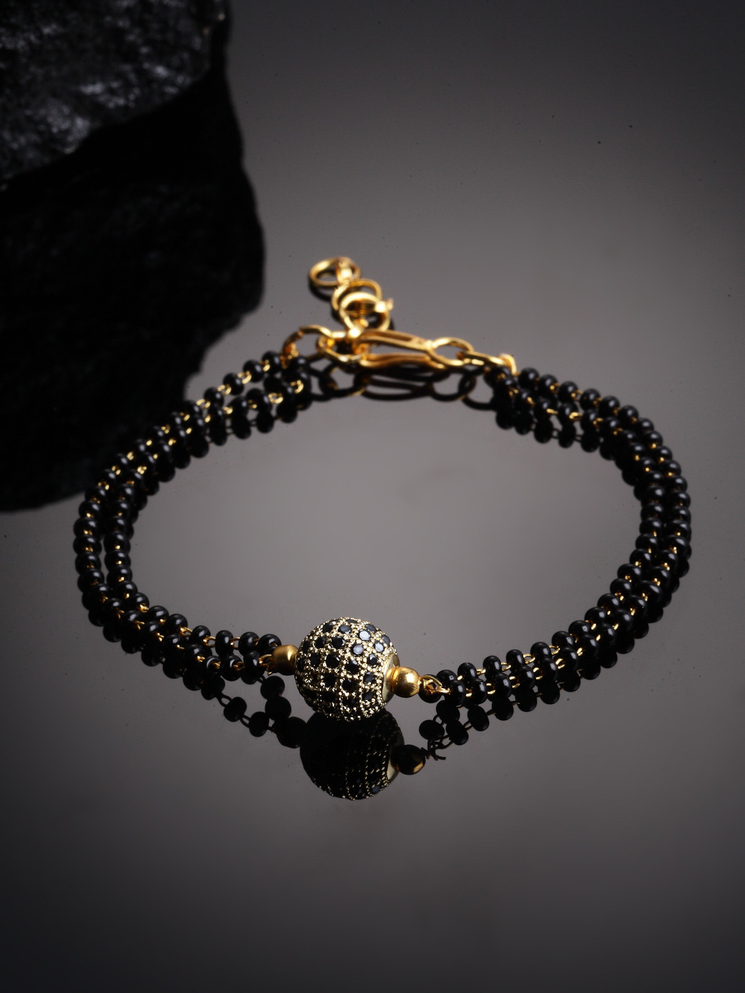 

PANASH Gold-Plated Black Stone-Studded & Beaded Hand Mangalsutra