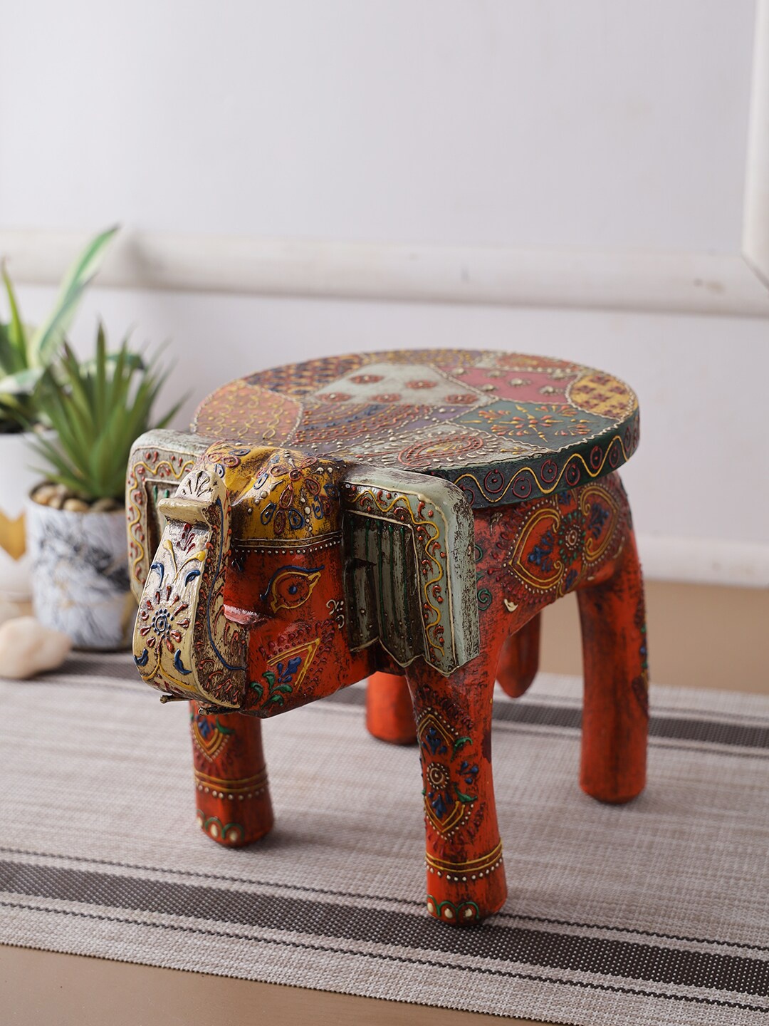 

Aapno Rajasthan Red & Yellow Wooden Painted Elephant Stool Showpiece