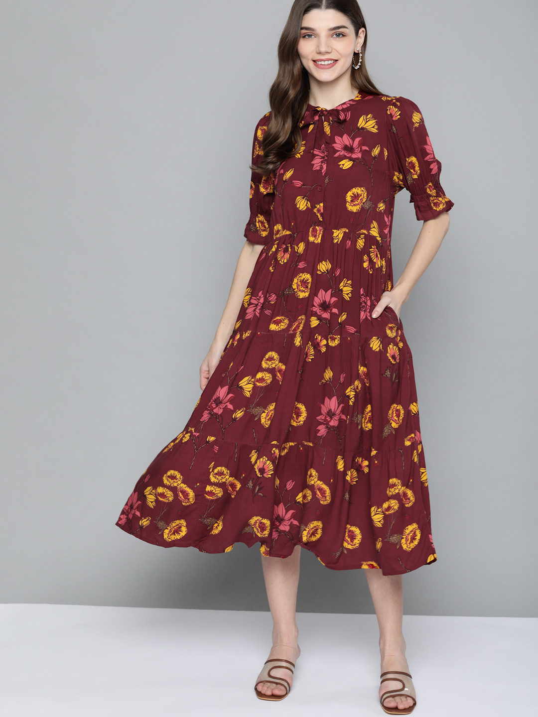 

Mast & Harbour Women Maroon & Mustard Yellow Floral Tie-Up Neck A-Line Tiered Midi Dress