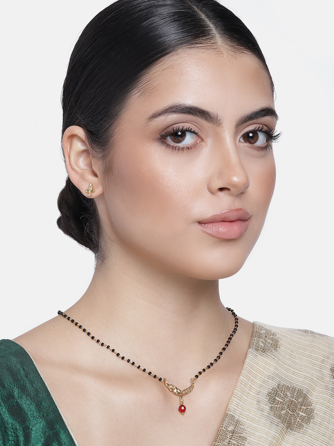 

Estele Gold Plated CZ floral Wave Designer with Ruby Bead Mangalsutra & Earrings Set