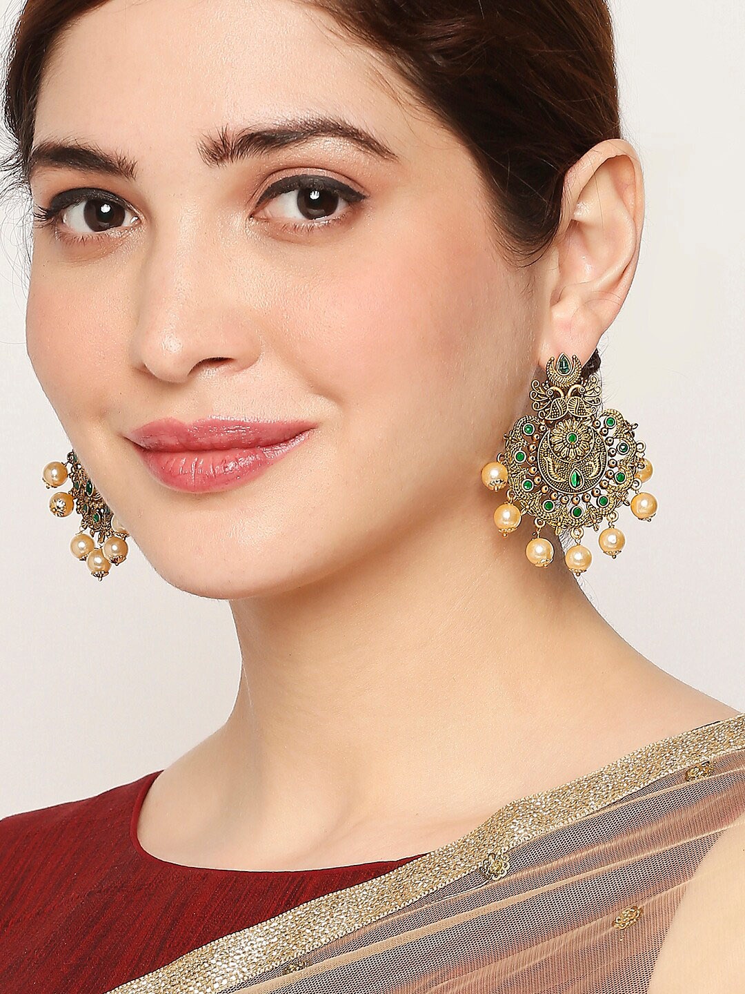 

OOMPH Gold-Toned & Green Stoned Peacock Shaped Chandbalis Earrings