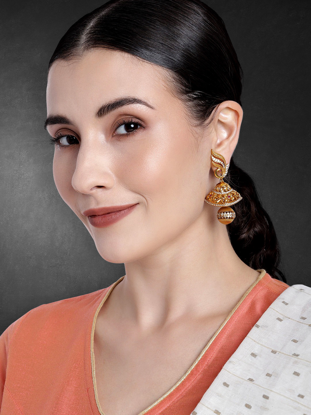

Peora Red & Golden Matte Gold Plated Dome Shaped Cubic Zirconia Studded Jhumkas