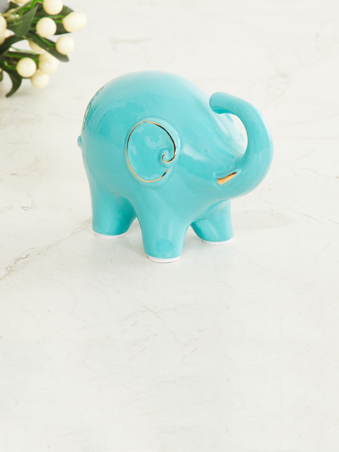 

Home Centre Teal Green Textured Ceramic Small Elephant Figurine