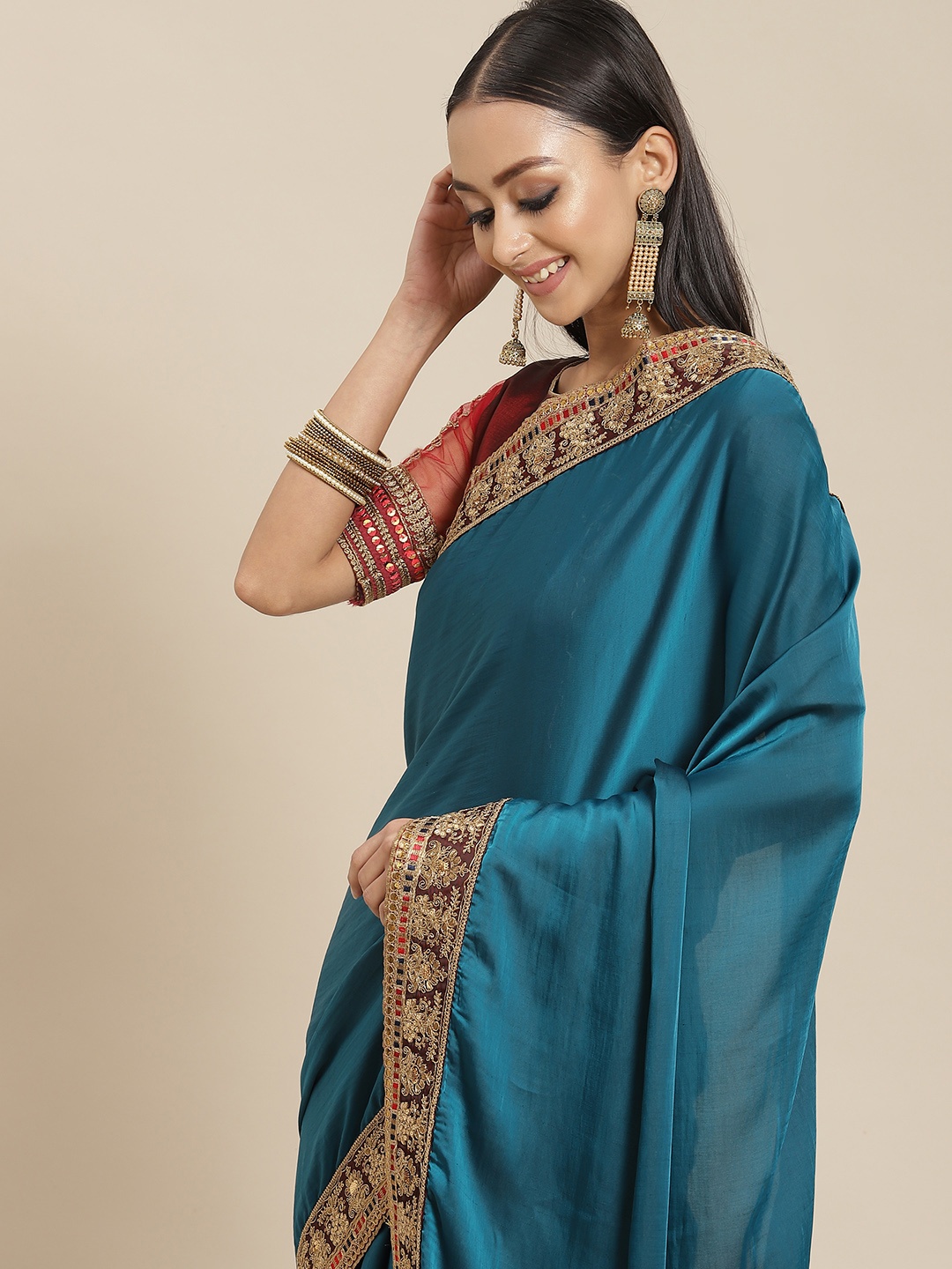 

Mitera Teal Blue & Golden Solid Saree