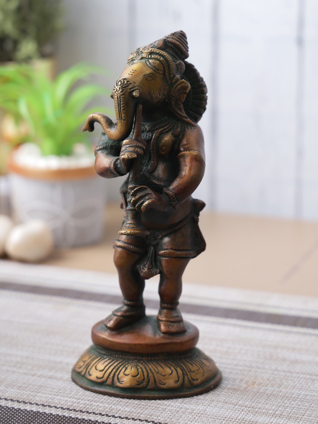 

Aapno Rajasthan Brown & Black Musical Lord Ganesha Showpiece