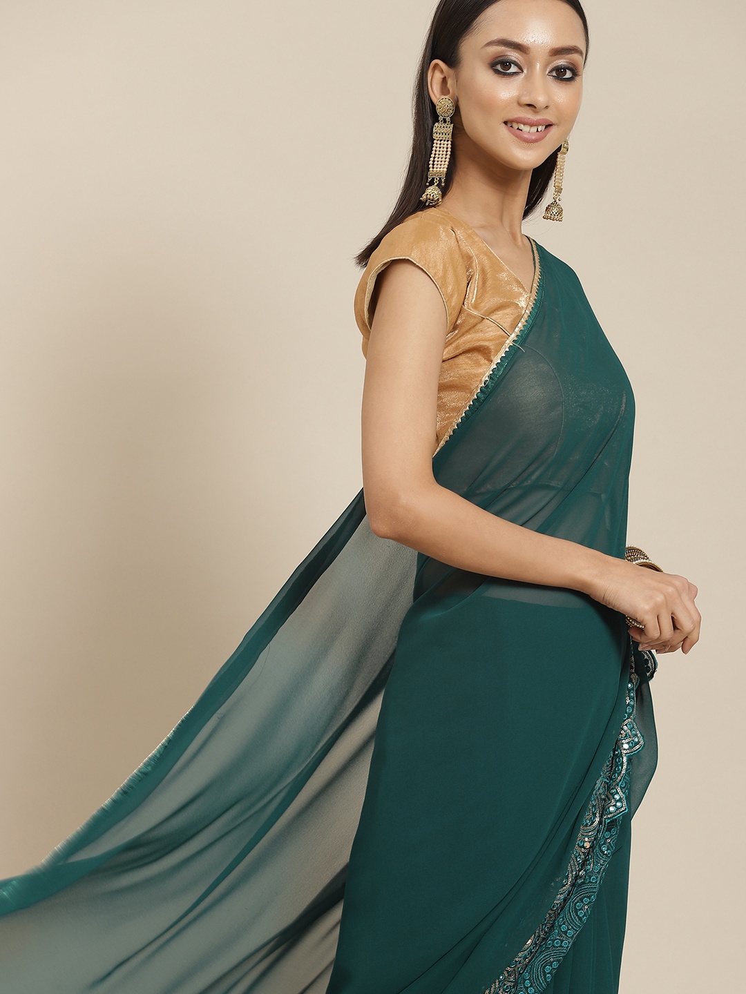 

Mitera Teal Green Solid Saree