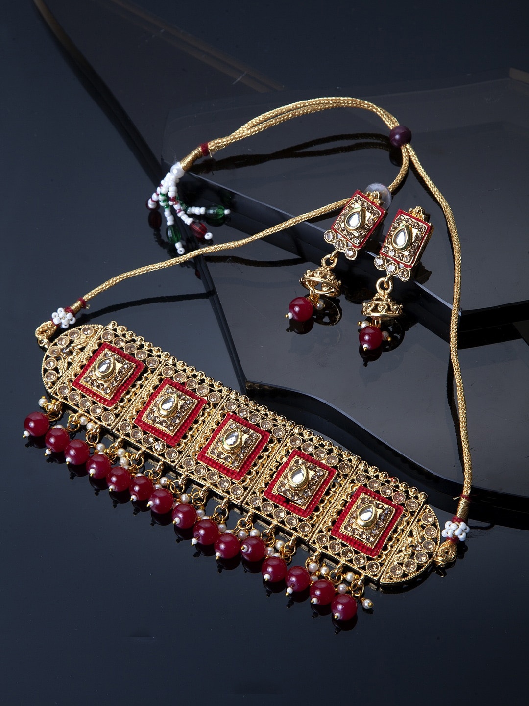 

Shining Diva Gold-Plated White Kundan Stone Studded & Red Beaded Jewellery set